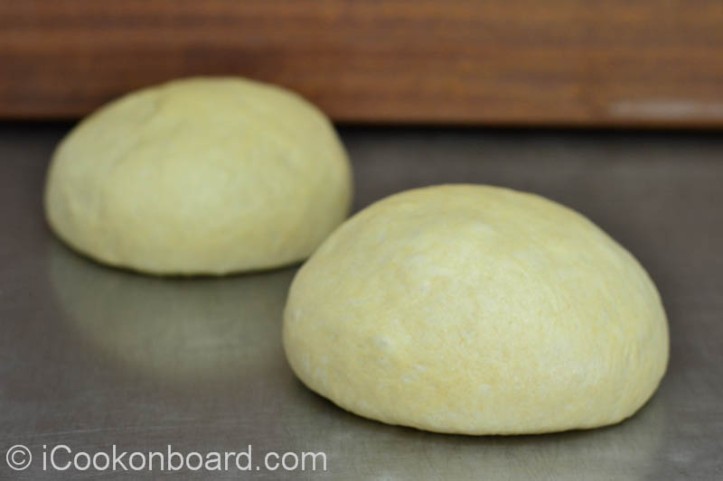 After you punch down the dough, divide it into two.